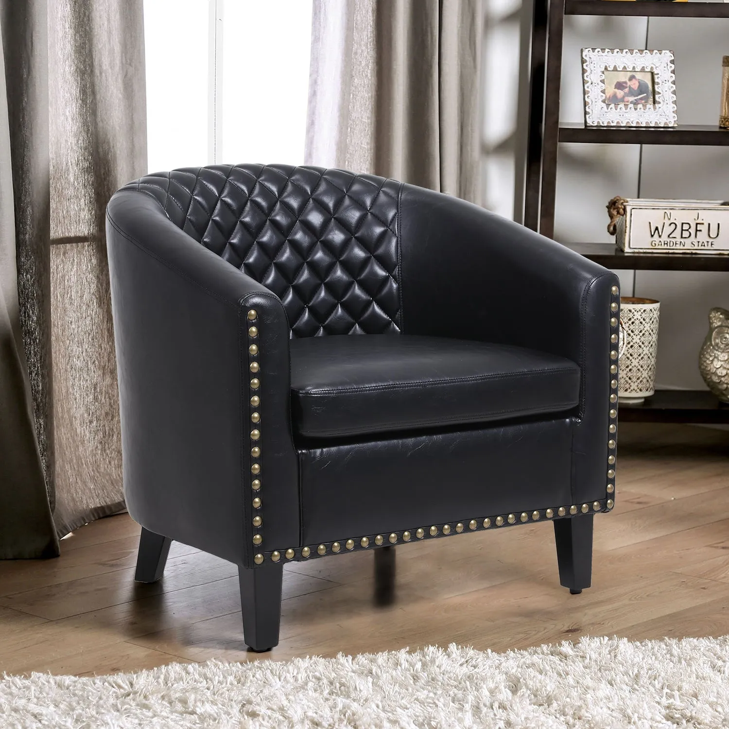Sleek Black Leather Barrel Accent Chair